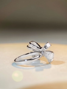 Detailed macro view of S925 silver bow ring with shimmering pave-set zircon stones