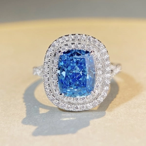 Luxury sterling silver ring featuring a large blue rectangular cushion cut stone halo setting