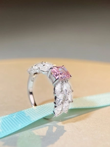 Macro side view of S925 silver ring featuring radiant cut pink stone on blue ribbon