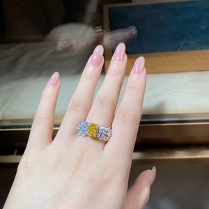 Detailed view of yellow radiant-cut gemstone ring with marquise diamond feathers