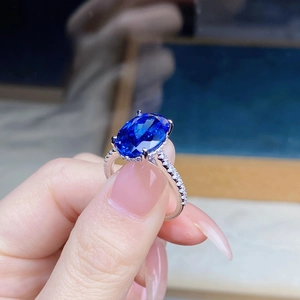 Macro detail of 6-carat oval sapphire silver ring with micro-pave diamond setting