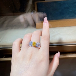 Macro detail of a bow-shaped S925 silver ring with a 2-carat yellow cushion cut gemstone