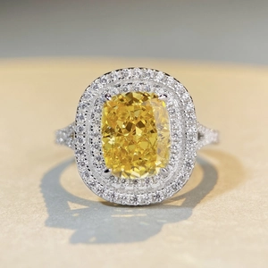 Luxurious cushion-cut yellow gemstone ring with double halo diamonds and split shank band