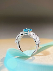 Macro view of aquamarine silver ring with butterfly wings and ice flower cut diamond halo
