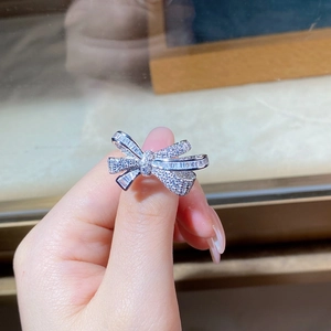 Macro detail of S925 sterling silver bow ring with shimmering baguette zircon inlay