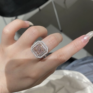 Macro shot of S925 silver ring featuring square cushion cut pink gemstone and halo diamonds