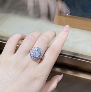 Close-up of cushion-cut radiant diamond ring with double halo on silver band