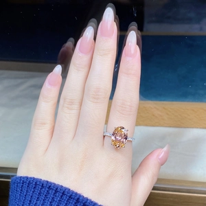 Close-up of a 6 carat oval pink sapphire ring in S925 silver with pavé diamond band