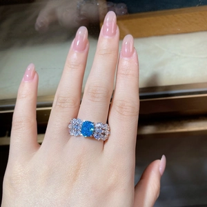 Macro detail of aquamarine ring featuring butterfly wings and rectangular main stone