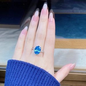 Close-up of S925 sterling silver ring with oval aquamarine stone and pave diamonds
