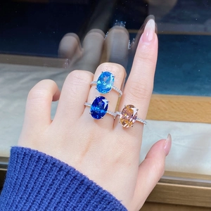 Detailed close-up of three S925 silver rings with oval gemstones in blue and champagne