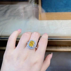 Close-up of luxury S925 silver ring featuring a yellow halo gemstone and pavé diamonds