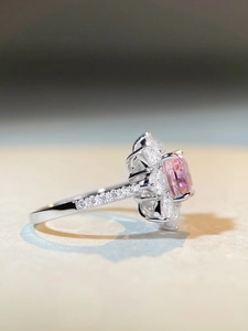 Macro side view showing pink cushion-cut main stone and marquise diamond flower setting