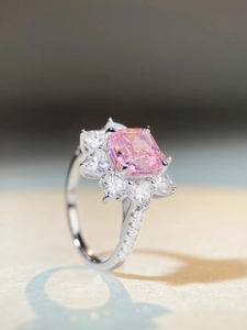 Macro shot of S925 sterling silver ring with pink cushion cut stone in flower halo
