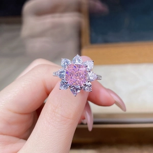 Macro shot of S925 silver ring featuring a pink cushion-cut stone and flower petal halo