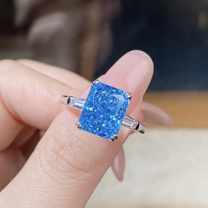 Macro shot of S925 silver ring featuring radiant cut blue zircon and side stones