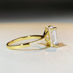 Detail view of the 18K gold-plated emerald cut ring with a sparkling halo setting