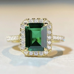 Classic 18K gold plated 925 silver ring featuring emerald cut green gemstone with halo diamonds
