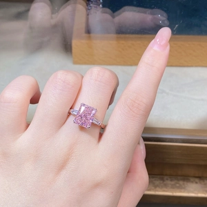 Macro shot of S925 silver ring featuring radiant cut pink stone and side baguette stones