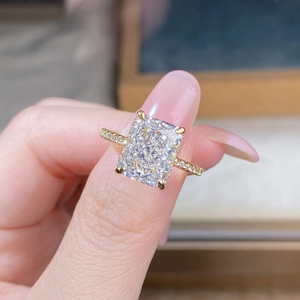 Detail of 18K gold S925 silver ring featuring a rectangle cut gemstone and pavé band