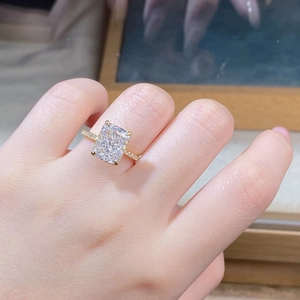 Close-up of radiant cut crystal on 18K gold plated S925 silver ring with side stones