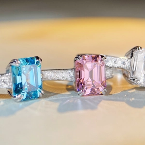 Emerald cut aquamarine and pink sapphire rings with micro-pave diamond silver bands