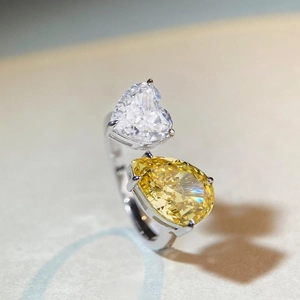 Adjustable S925 silver ring featuring heart and pear cut diamonds on stone surface