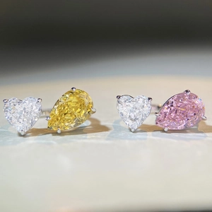 Detail view of Toi et Moi heart and pear cut rings with multicolor sparkling gemstones