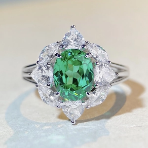 Elegant S925 silver ring with oval green gemstone and floral petal zirconia cluster
