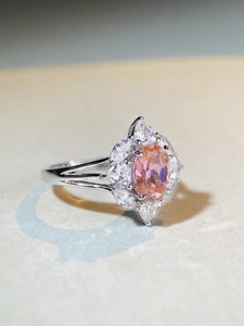 Macro side view of S925 silver ring featuring pink oval gemstone and marquise accents