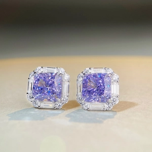 Macro shot of S925 silver stud earrings with square purple zircon and baguette halo