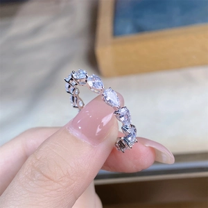 Macro shot of S925 sterling silver ring featuring pear-cut clear gems in a claw setting