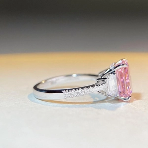 Macro side view of S925 silver ring featuring radiant cut pink stone and side trapezoid gems
