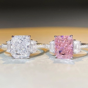 Radiant cut silver ring with white and pink stones in a high-shine three-stone setting