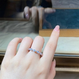 Macro shot of S925 sterling silver ring featuring ice blue pear-shaped crystals in row setting