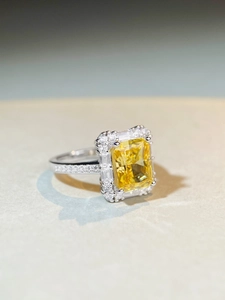 Detailed close-up of S925 silver ring featuring a yellow radiant cut zircon center stone