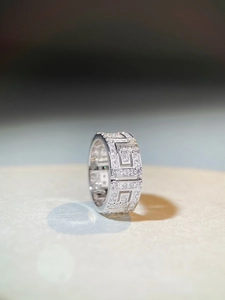 Macro shot of S925 sterling silver ring featuring geometric hollow patterns and pavé zircons