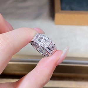 Macro detail of S925 sterling silver ring featuring geometric hollow patterns and pavé zircons