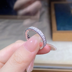 Macro shot of silver eternity ring with three rows of sparkling zircon micro-pave setting