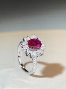 Macro shot of oval ruby ring with flower petal cluster setting in S925 sterling silver