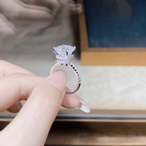 Detailed close-up of a square-cut moissanite ring in S925 silver with a double-halo setting