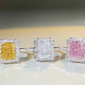 Macro view of three halo radiant cut S925 silver rings with yellow, white and pink stones