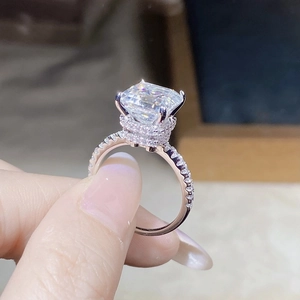 Detailed close-up of radiant cut moissanite ring in rose gold with pave diamond setting