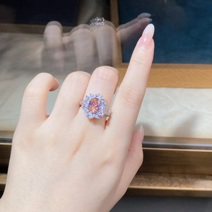 Macro view of flower shaped S925 silver ring with pink orange gemstone and zircon