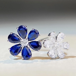 Elegant 925 sterling silver open ring featuring blue and white zircon flower petals