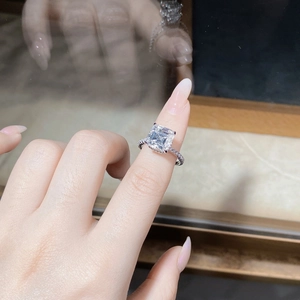 Detailed view of large square cut moissanite ring with pavé diamonds on S925 silver band