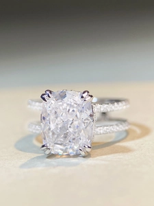 Macro shot of cushion-cut zircon ring with double row split band and micro-pave diamonds