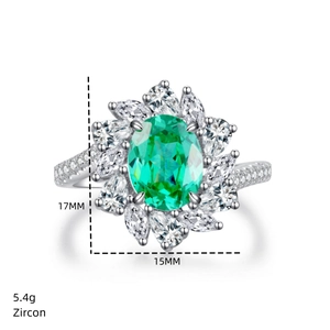 Close-up of S925 silver ring with oval green zircon and pear-cut halo setting
