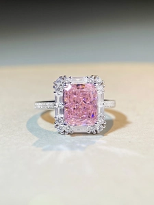 Close-up of radiant cut pink zircon ring in 925 silver with sparkling halo setting