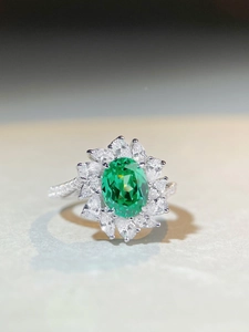 Macro shot of oval Paraiba tourmaline ring with sparkling marquise diamond halo